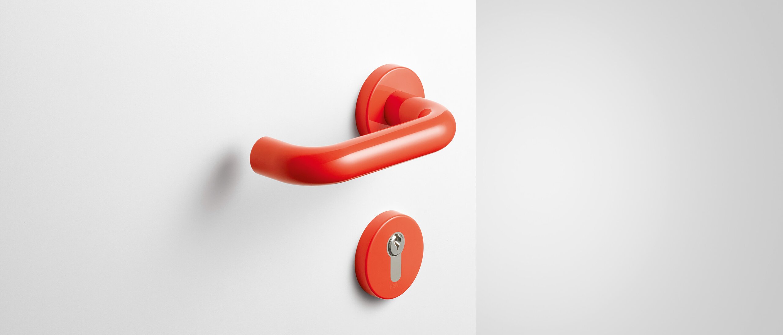 Lever handle with key rosette in the color coral made of polyamide