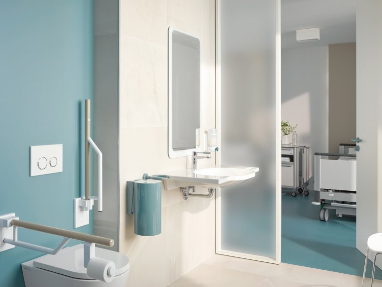 Barrier-free patient bathroom equipped with white and blue sanitary accessories