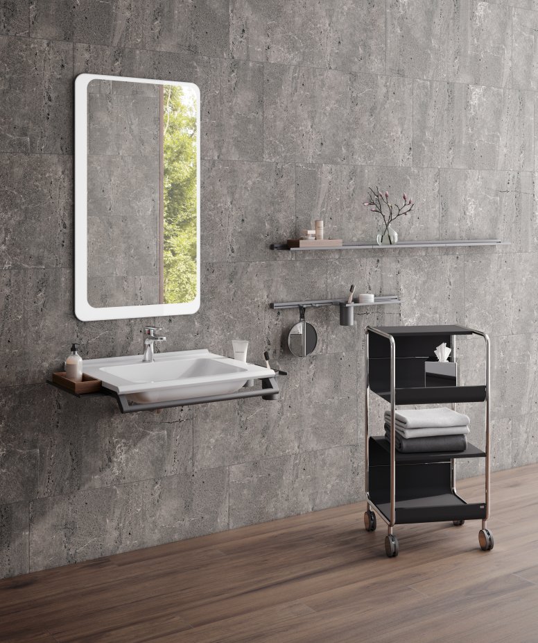 Modular washbasin with grab rail and shelves, side trolley next to it in matt black